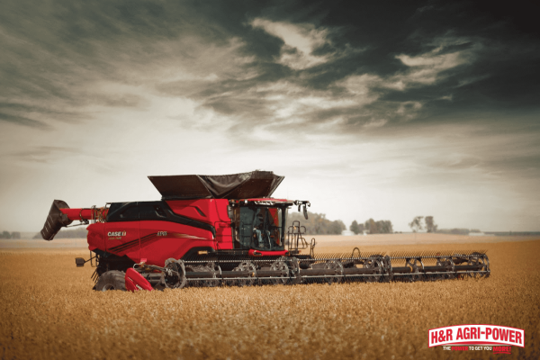 Case IH combine operating in a wheat field, highlighting hydraulic systems and fluid maintenance for efficient harvesting