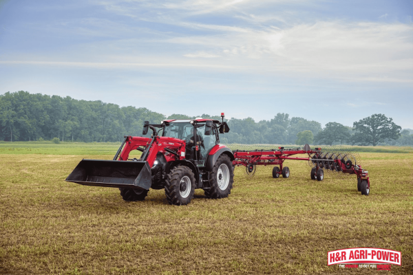 Case IH tractor with rake attachment maintaining field performance and reliability across Illinois farmland