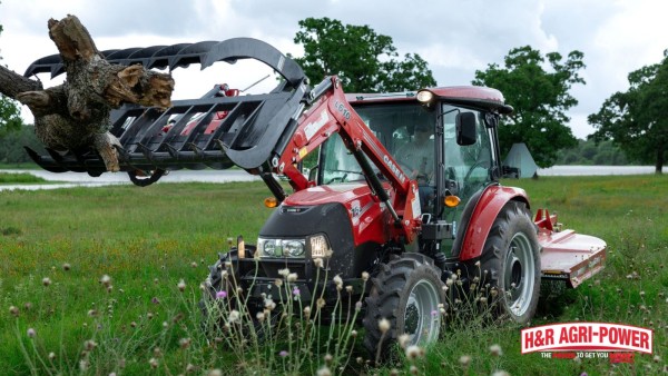 Case IH tractor with grapple and rotary cutter for pasture maintenance and equipment upkeep