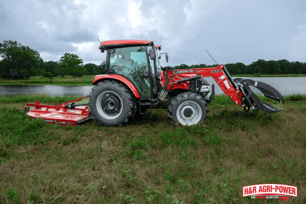 Case IH tractor with mower attachment in a grassy field, representing proper storage and protection during winter months
