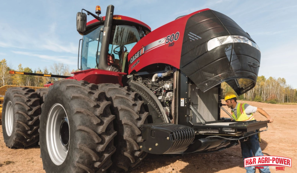 Technician servicing a Case IH Steiger 500 HD tractor engine for reliable equipment performance at H&R Agri-Power