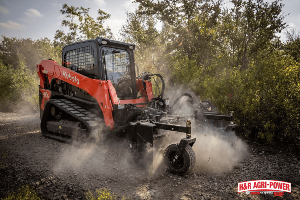 Kubota compact track loader grading a gravel surface, emphasizing cost efficiency and long-term value for construction projects