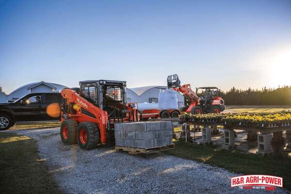 Kubota skid steer and wheel loader handling materials on a farm, highlighting maintenance support and dealer service in Kentucky