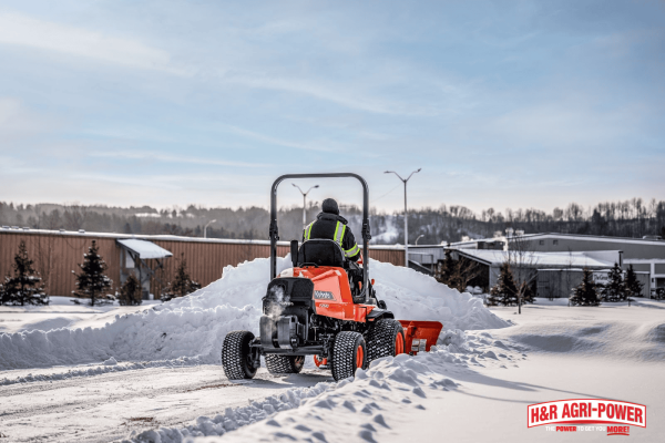 Kubota equipment operating in snowy conditions, emphasizing proper storage and protection during winter months