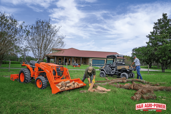 Kubota tractor and utility vehicle handling logs on a farm, illustrating how to choose the right equipment for specific farm operations