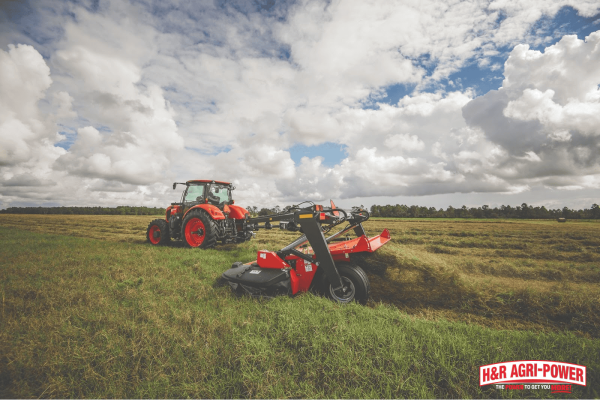 Kubota tractor using a rotary cutter to maintain pasture land, illustrating practical equipment financing options for Illinois farmers.