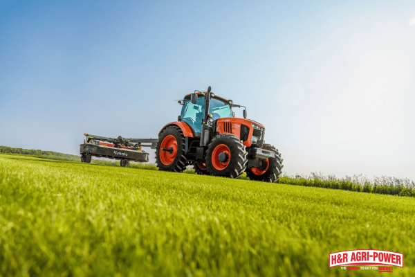 Kubota tractor mowing a field, highlighting the importance of seal replacement and system maintenance in humid environments