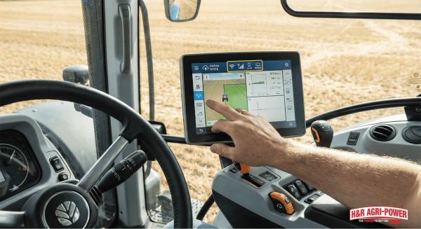IntelliView touchscreen in New Holland cab showing PLM Intelligence and field data sync.