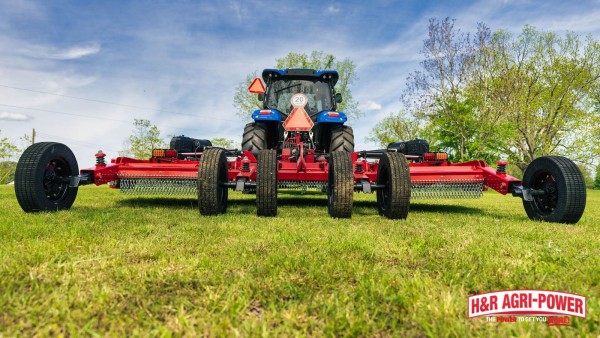 New Holland tractor with Bush Hog flex-wing rotary cutter for preventative maintenance and field reliability