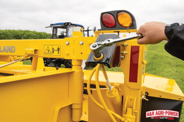 Close-up of equipment adjustment using a wrench, illustrating how heavy-use conditions impact service interval timing