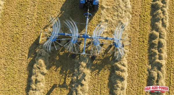 Aerial view of New Holland ProTed tedder spreading hay with uniform pattern.