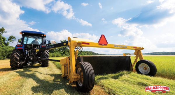 New Holland rotary rake forming windrows in hay field for efficient forage harvesting