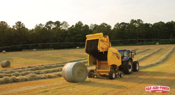 New Holland round baler operating in field with precision farming technology integration