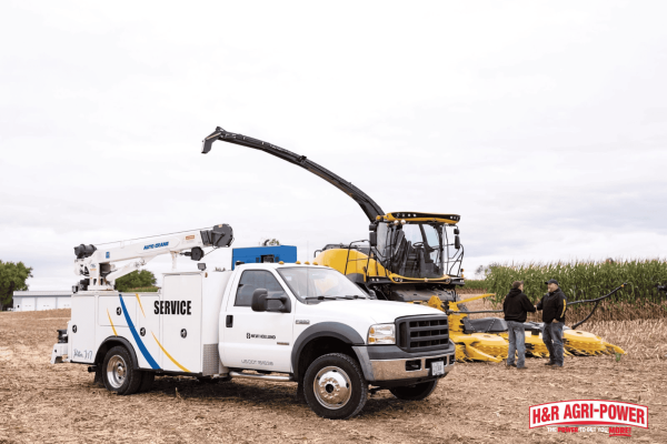 H&R Agri-Power service truck assisting New Holland equipment in the field, representing professional service interval support