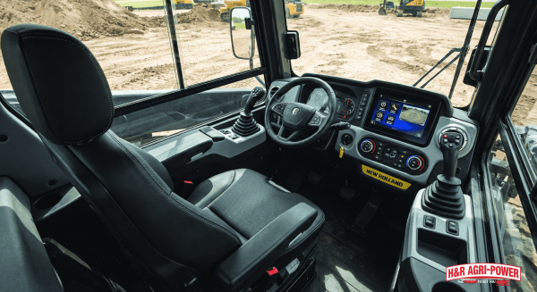 Interior of New Holland skid steer showing ergonomic controls and operator interface.