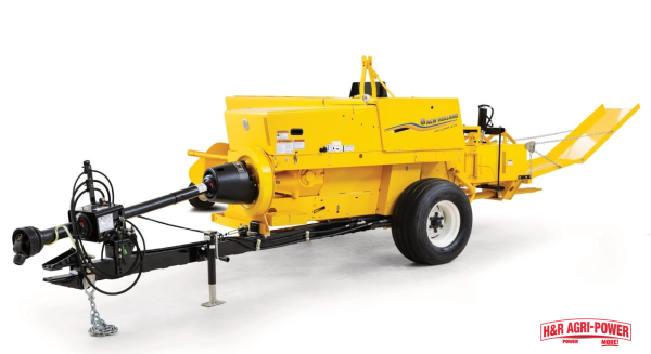 New Holland square baler side view showing PTO shaft and hitch assembly for routine maintenance and performance checks