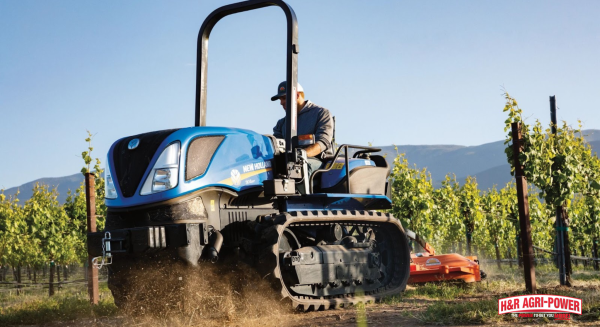New Holland tracked tractor operating between vineyard rows demonstrating efficient fuel usage in challenging terrain