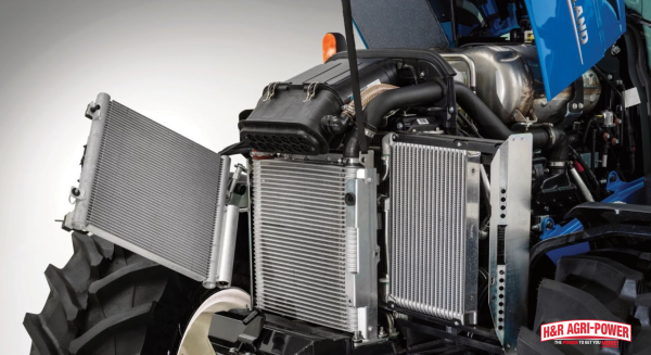 Open engine compartment on New Holland tractor showing accessible components for routine maintenance