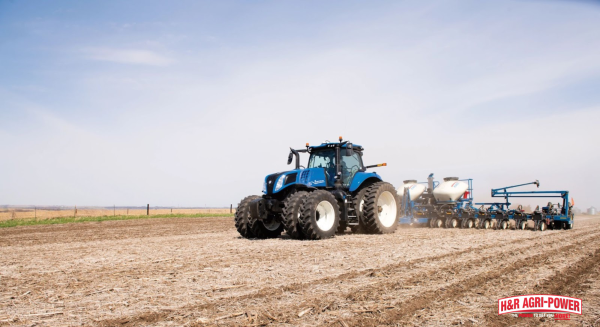 New Holland tractor operating in field during planting season, showcasing performance during critical farming periods
