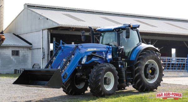 New Holland farm tractor with front loader near barn, representing financing and leasing options available in 2026