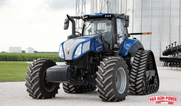 New Holland tractor parked near farm structures highlighting importance of proper equipment knowledge and operation