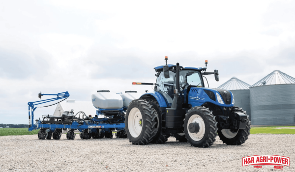 New Holland tractor with planter near grain bins representing long-term equipment value and investment
