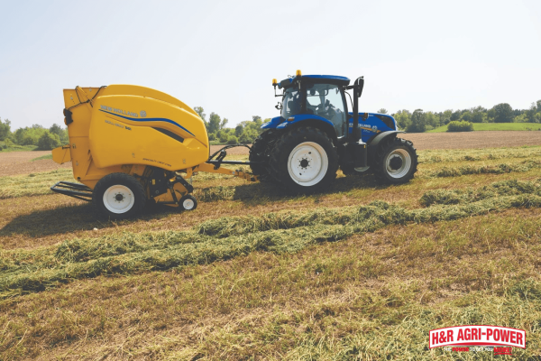 New Holland tractor pulling baler across a field, emphasizing preventative maintenance to reduce breakdowns and improve efficiency