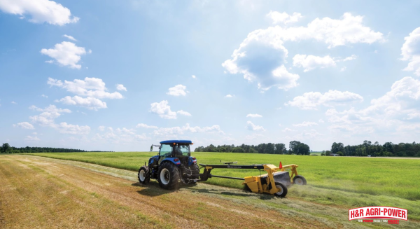 New Holland tractor operating mower attachment, highlighting proper PTO maintenance and driveline care