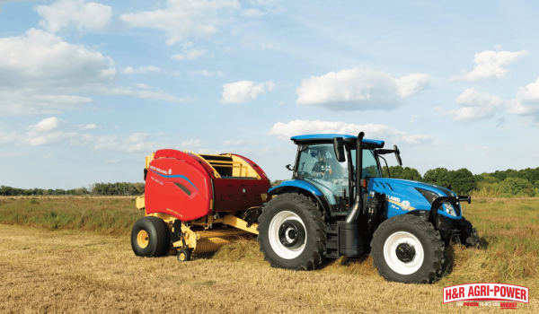 New Holland tractor with round baler operating in field for large-scale agricultural production