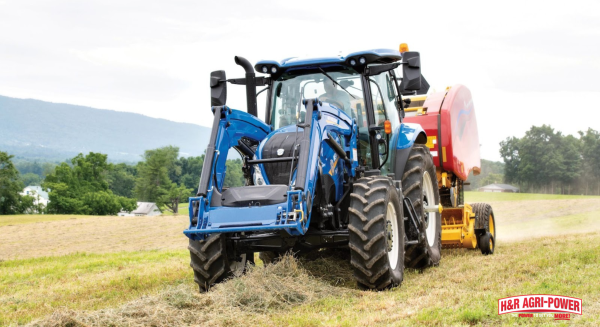 New Holland tractor operating round baler in hay field for mixed farming operations