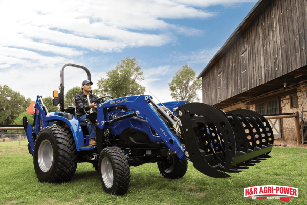 New Holland tractor with grapple attachment near a barn, representing routine servicing of major tractor components