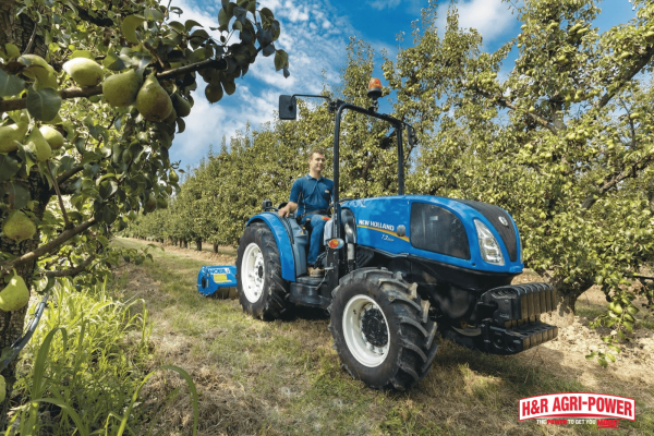 New Holland tractor operating in an orchard, emphasizing proper storage conditions to maximize equipment lifespan