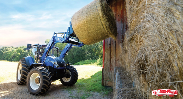 New Holland tractor loading hay bales, symbolizing farm equipment financing and potential tax benefits