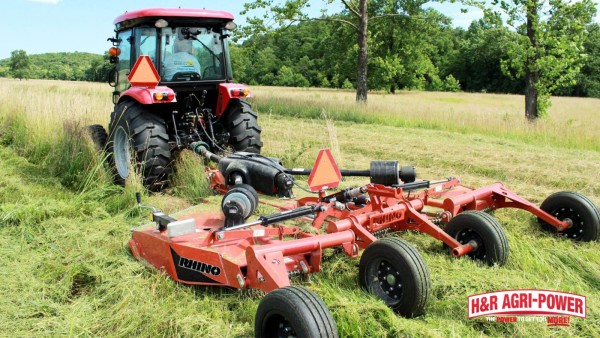 Rhino rotary cutter yoke and driveline connected to a tractor for heavy field mowing
