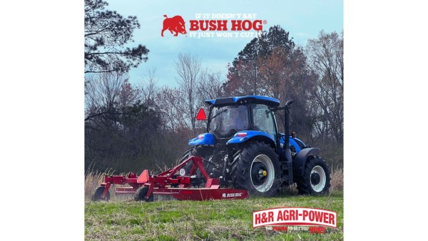 Tractor operating a Bush Hog rotary cutter through tall grass and brush.