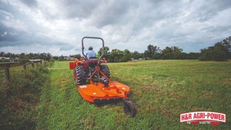 tractor rotary cutter field stormy sky