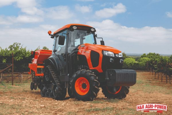 Kubota tractor operating in a field while demonstrating hydraulic system operation during air bleeding process
