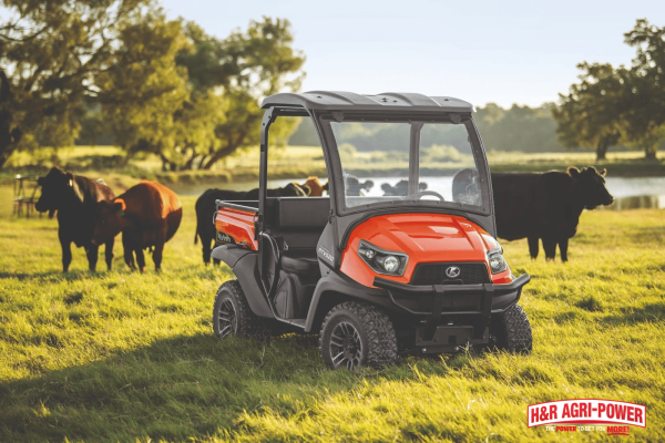 Kubota RTV utility vehicle parked on grass showing suspension stability and ride comfort during farm use
