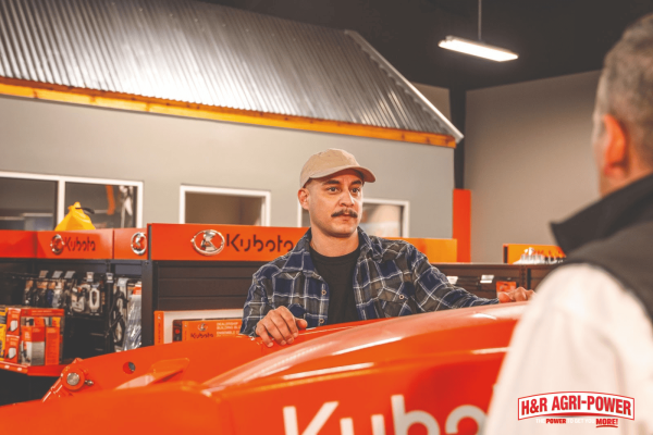 Customer speaking with a Kubota service specialist at an H&amp;R Agri-Power dealership in Mississippi about equipment maintenance and service support.