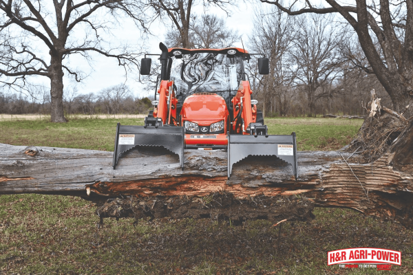 Kubota tractor using front loader attachment, showcasing strong hydraulic performance after proper system maintenance