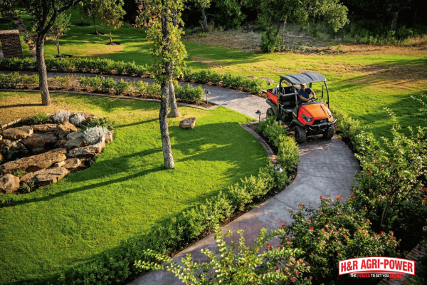 Utility vehicle driving slowly on a sloped path to demonstrate rollover prevention and safe hillside operation